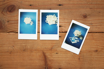 Fototapeta premium three instant photo of white flower on wood background, picture in picture