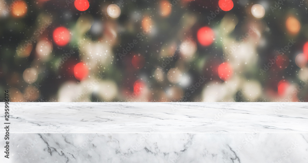 Aufkleber marble table top with abstract blur christmas tree red decor ball and snow fall background with bokeh light,winter Holiday backdrop,Mock up banner for display of product or promotion