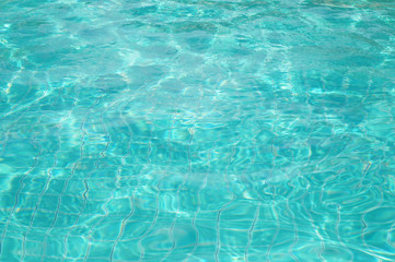 Background of rippled pattern of clean water in swimming pool 