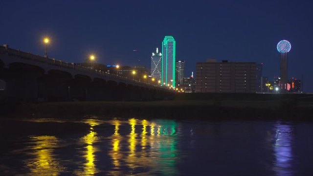 Dallas Skyline at NIGHT with the Trinity River in the foreground. Fast moving water -  Time Lapse