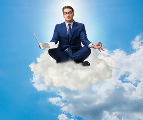 Businessman working on laptop in the sky