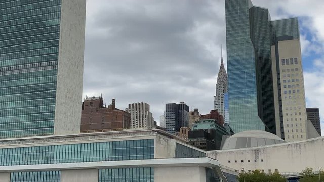 New York skyline Emire State building filmed from boat at Hudson river passing by.