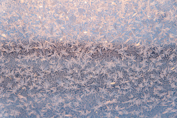 Abstract winter background with copy space. Winter texture of the frosty patterns. Soft focus and sunlight.