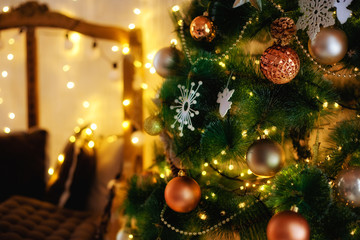 Fototapeta na wymiar Christmas tree with lights decoration brown balls