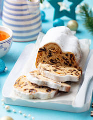 Christmas stollen cake with icing sugar, marzipan and raisins. Traditional Dresdner christ pastry.