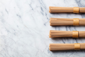 Noodles soba on marble background. Traditional Japanese food. Top view. Copy space.