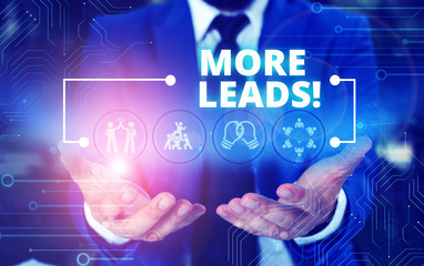 Handwriting text More Leads. Conceptual photo initiation consumer interest enquiry into products or services Male human wear formal work suit presenting presentation using smart device