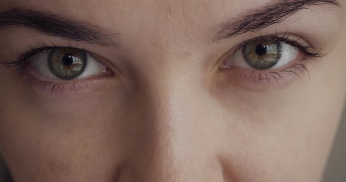 Close-up view on woman blinks and looks away.