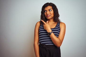 Naklejka premium Transsexual transgender woman wearing striped t-shirt over isolated white background Pointing aside worried and nervous with forefinger, concerned and surprised expression