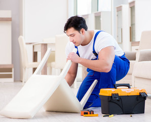 Furniture repairman working in store