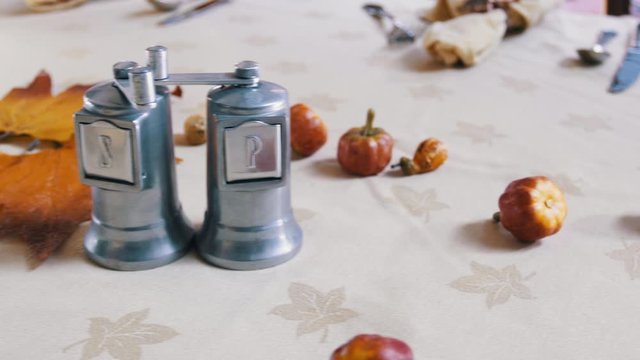 Salt and pepper grinder on table with thankgiving spread