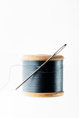 wooden spool of thread and needle