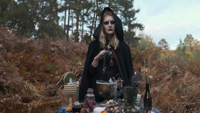 Young Witch Fortune-Tellers In The Forest. Halloween Image.