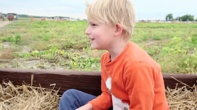 Genuine reaction of toddler on hay ride while jerking forward. Slomo