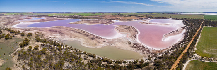 Aerial panoramic view of a large pink salt lake located next to highway 40 in the wheatbelt region of Western Australia