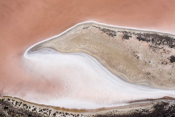 Abstract top down view of a large pink salt lake located next to highway 40 in the wheatbelt region of Western Australia