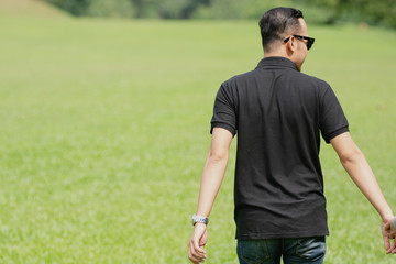 Young playful young muslim Asian couple  running together hand by hand on natural background