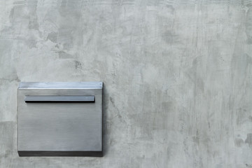 Photo of textured from empty old flat colorless cement wall and matt outdoors aluminum mailbox background.