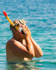 Man with snorkeling tube in sea