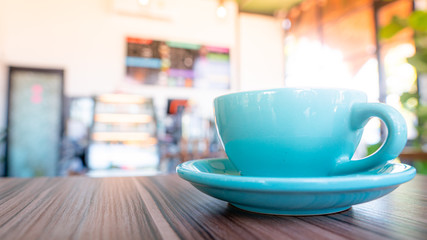 blue coffee cup top on wooden coffee shop background.