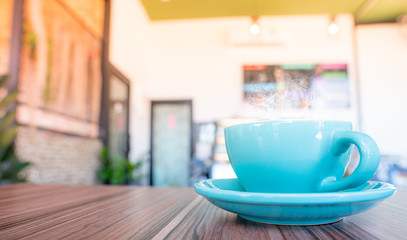 blue coffee cup top on wooden coffee shop background.
