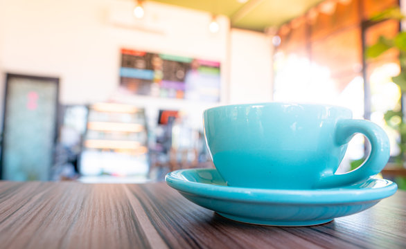 Blue Coffee Cup Top On Wooden Coffee Shop Background.