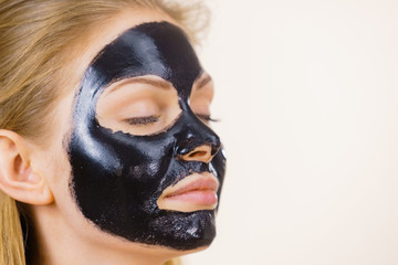 Girl black carbo peel off mask on face