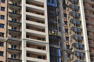 Builders work on a building facade