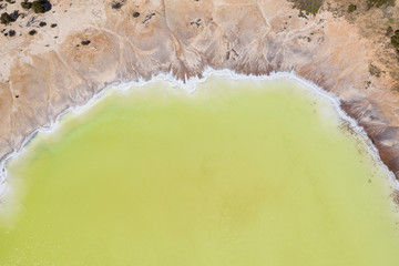Aerial view of the beautiful yellow salt lake known as Statues lake located next to highway 40 in the wheatbelt region of Western Australia