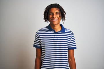 Afro man with dreadlocks wearing striped blue polo standing over isolated white background with a happy and cool smile on face. Lucky person.