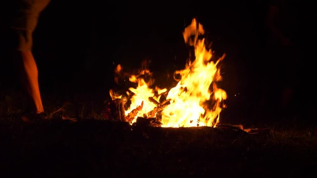 Three Man Jumps Over Campfire Flames After Each Other, Slow Motion