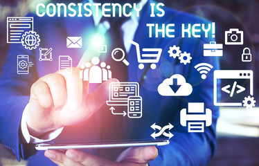 Word writing text Consistency Is The Key. Business photo showcasing by Breaking Bad Habits and Forming Good Ones Male human wear formal work suit presenting presentation using smart device