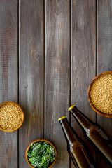 Barley and hop for making beer on dark wooden background top view copy space