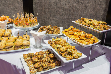 Buffet table of reception with burgers, cold snacks, meat and salads
