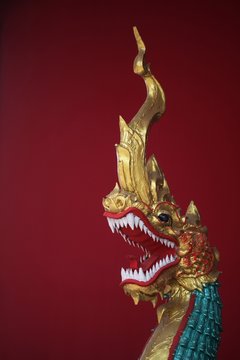 Golden dragon figure on a red background