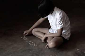 Young girl sit on the floor writing help me