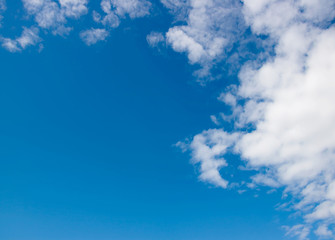Pure white clouds floating in the bright blue sky. The cool air will make the body fresh. Sitting and looking at the blue sky helps the body to have energy. The sky is slightly clouded.