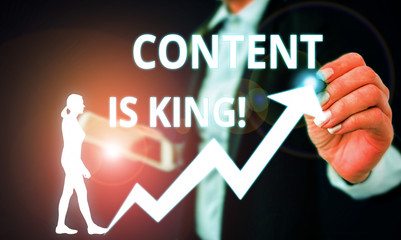 Conceptual hand writing showing Content Is King. Concept meaning marketing focused growing visibility non paid search results Female human wear formal work suit presenting smart device