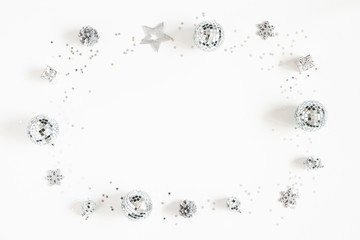Christmas composition. Frame made of christmas silver decorations on white background. Flat lay, top view, copy space