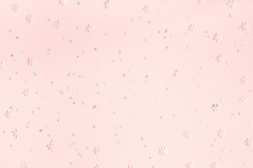 Christmas composition. Confetti, snowflake decorations on pastel pink background. Christmas, winter, new year concept. Flat lay, top view, copy space