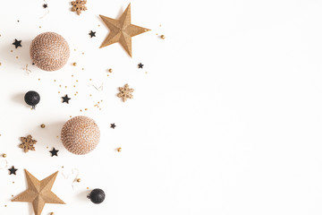 Christmas composition. Golden and black decorations on white background. Christmas, winter, new year concept. Flat lay, top view, copy space