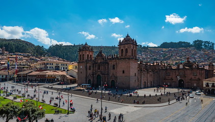 Aerial panoramic view of Cusco Cathedral from Main Square (Plaza de Armas). Perfect view with contrasts blue sky, cityskyline and traditional colonial architecture. City of Cusco, Peru - obrazy, fototapety, plakaty