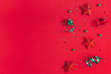 Christmas composition. Pattern made of christmas decorations on red background. Flat lay, top view, copy space