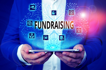 Handwriting text writing Fundraising. Conceptual photo act of collecting or producing money for a particular purpose Male human wear formal work suit presenting presentation using smart device