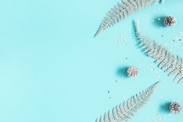 Christmas composition. Silver decorations on pastel blue background. Christmas, winter, new year concept. Flat lay, top view, copy space