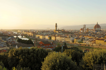 Fototapeta na wymiar Florence city during golden sunset. Panoramic view of the river Arno with Ponte Vecchio bridge, Palazzo Vecchio palace and Cathedral of Santa Maria del Fiore (Duomo), Florence, Italy.