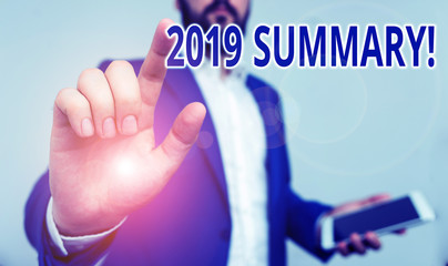 Conceptual hand writing showing 2019 Summary. Concept meaning summarizing past year events main actions or good shows Businessman pointing with pen in empty copy space