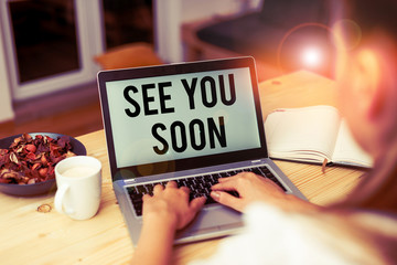 Handwriting text See You Soon. Conceptual photo used for saying goodbye to someone and going to meet again soon woman laptop computer smartphone mug office supplies technological devices