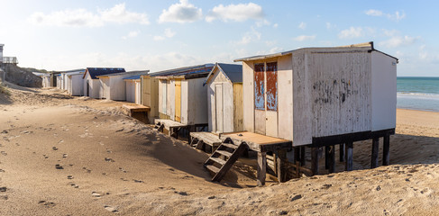 Obraz na płótnie Canvas France, Pas de Calais, Calais, beach huts face the sea during a beautiful sunny day
