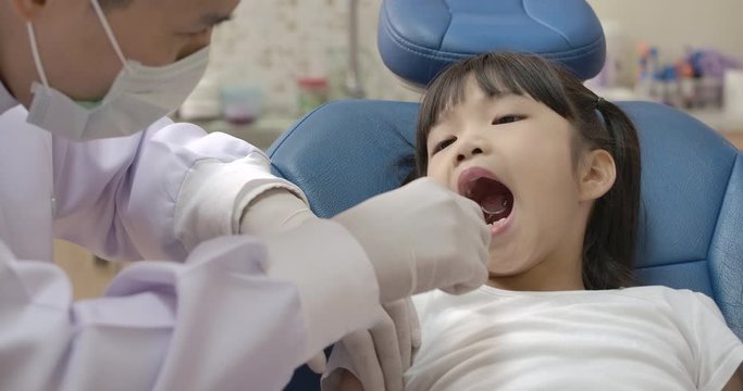 Little asian girl patient visiting dentist in dental clinic. Dental care concept.